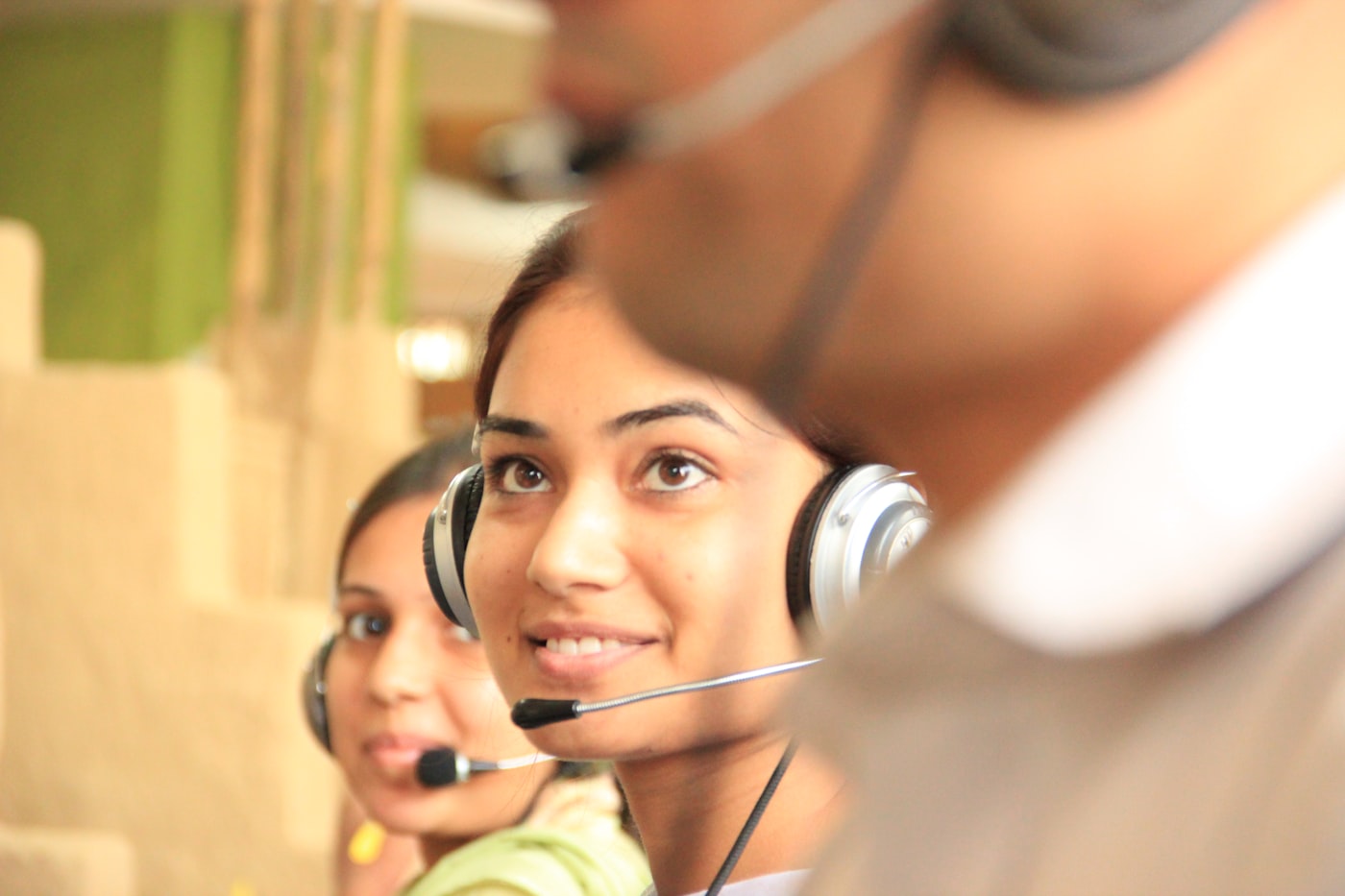 Customer support agent at workstation wearing a headset