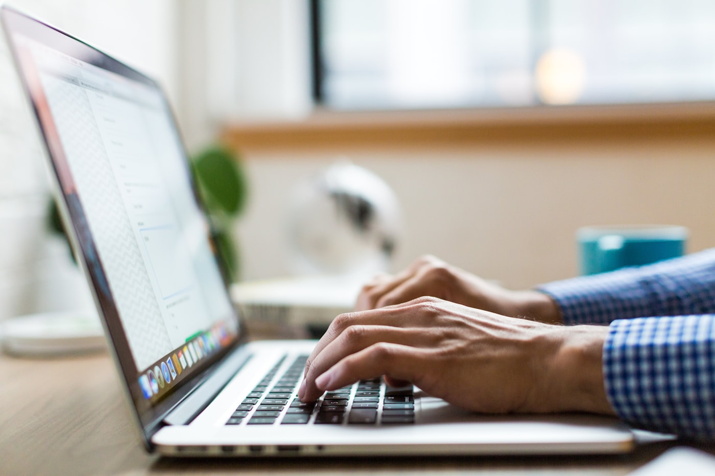 Hands typing on a laptop replying to a customer chat
