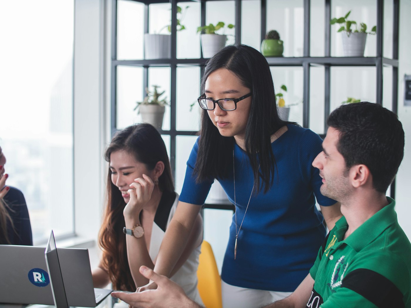 Two support agents collaborating at a shared desk
