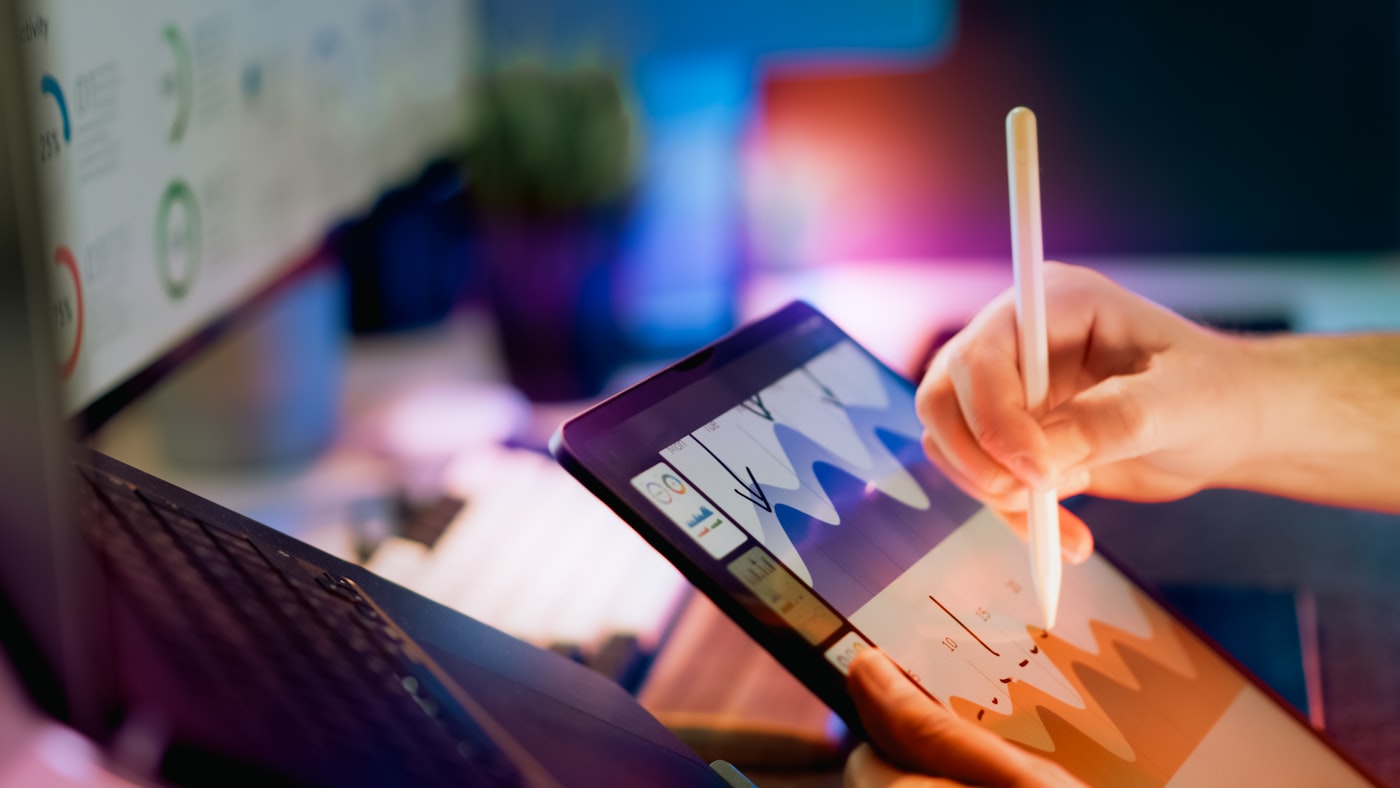 Marketer planning a campaign on a tablet with charts
