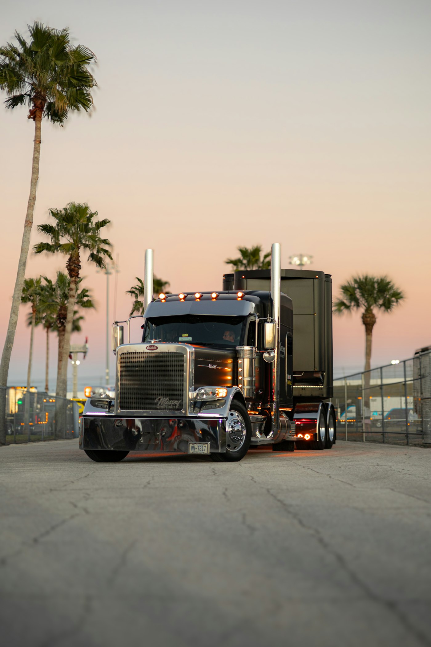 Semi truck on a highway at sunset, hauling freight